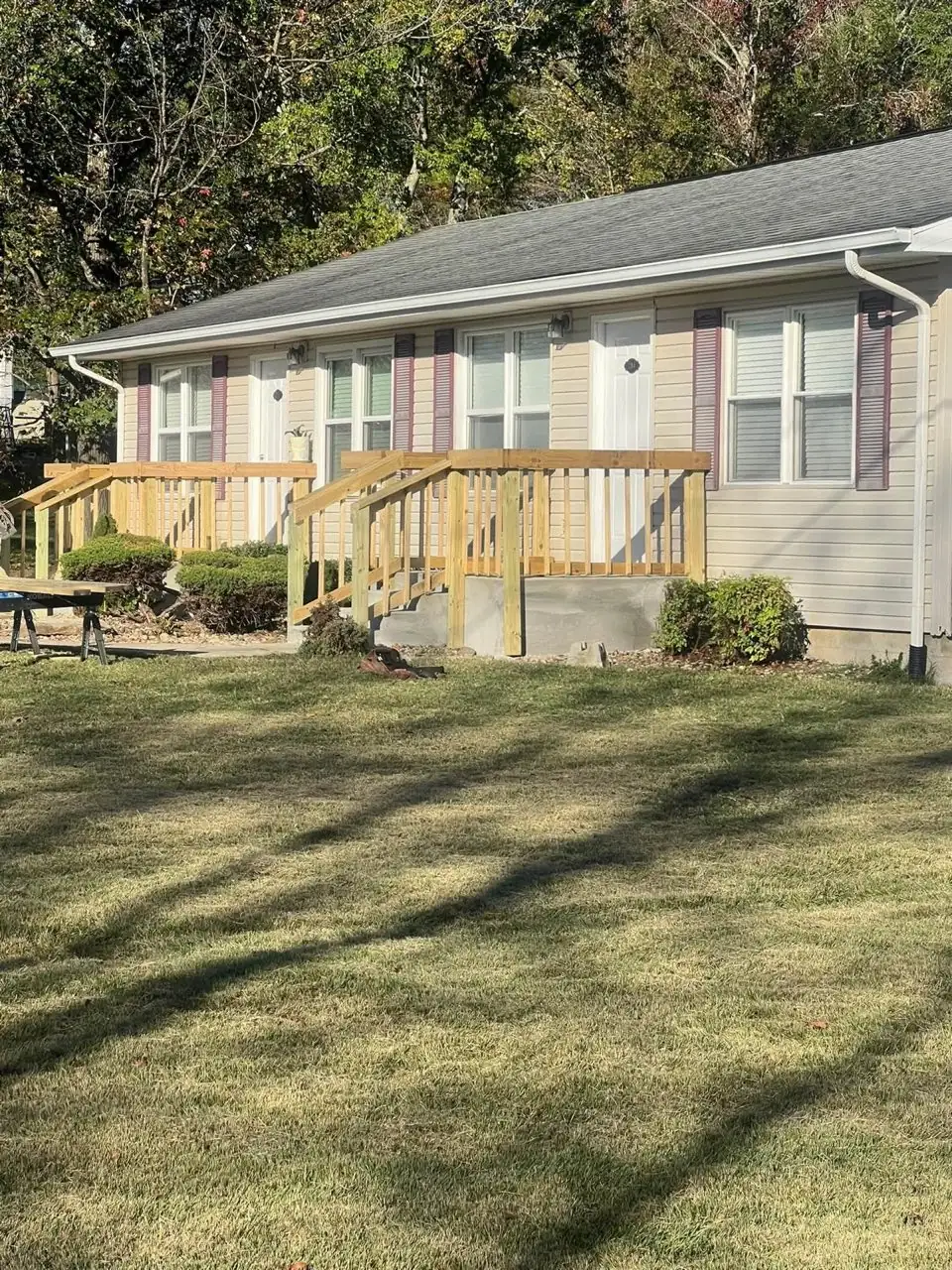 New pressure-treated wood deck and railing on home exterior