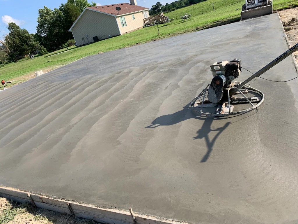 Power trowel finishing a large fresh concrete slab